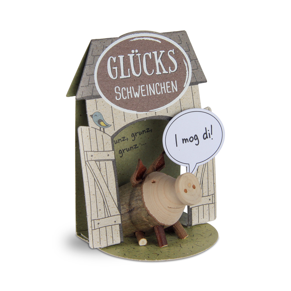 Glücksschweinchen sitzend: "I mog di!"